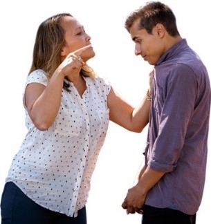 A woman threatening to punch a young man
