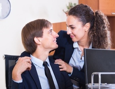 A woman with her hands on a man's shoulders