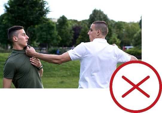 A man threatening to punch another man. There is a cross next to the image.