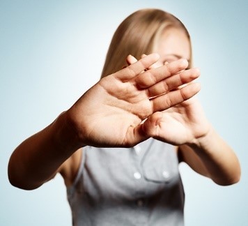 A woman putting her hands over her eyes