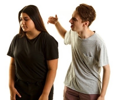 A man yelling with his hand raised at a woman